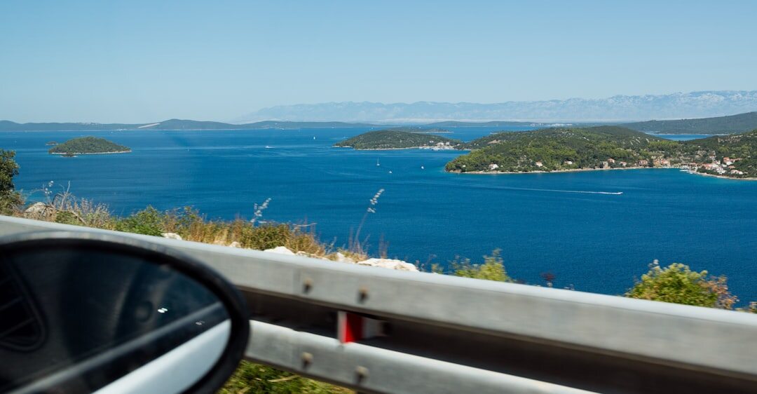 Group of seniors on a guided day trip admiring a scenic Croatian coastal view