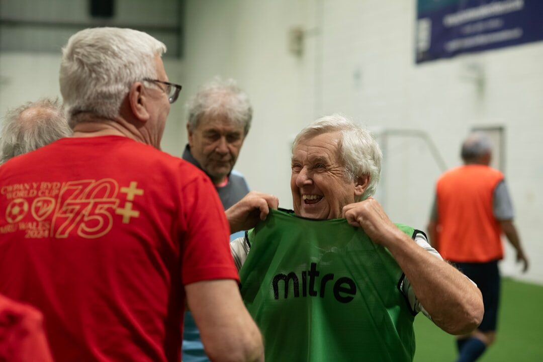 Seniors doing a gentle group exercise session led by an instructor
