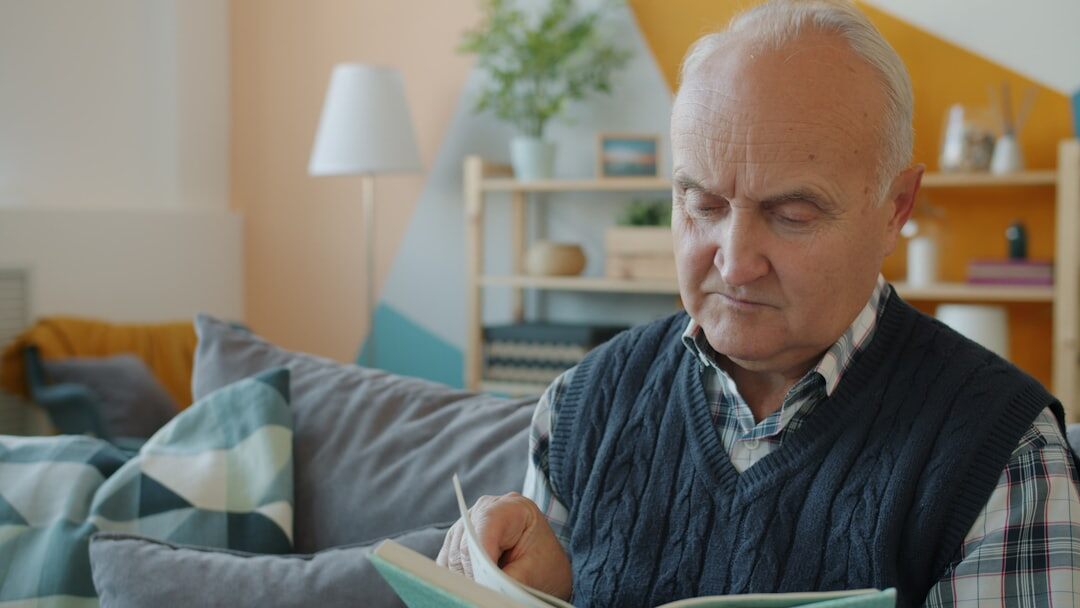 senior citizen using laptop at home
